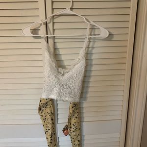 Lace crop top with adjustable straps.